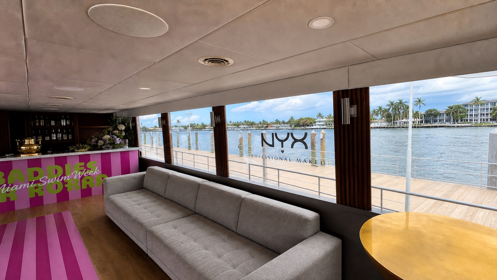 Custom striped bar wrap, pink floor vinyl, and NYX Professional Makeup window graphics on a Miami yacht for the Body Yachty Swim Week event