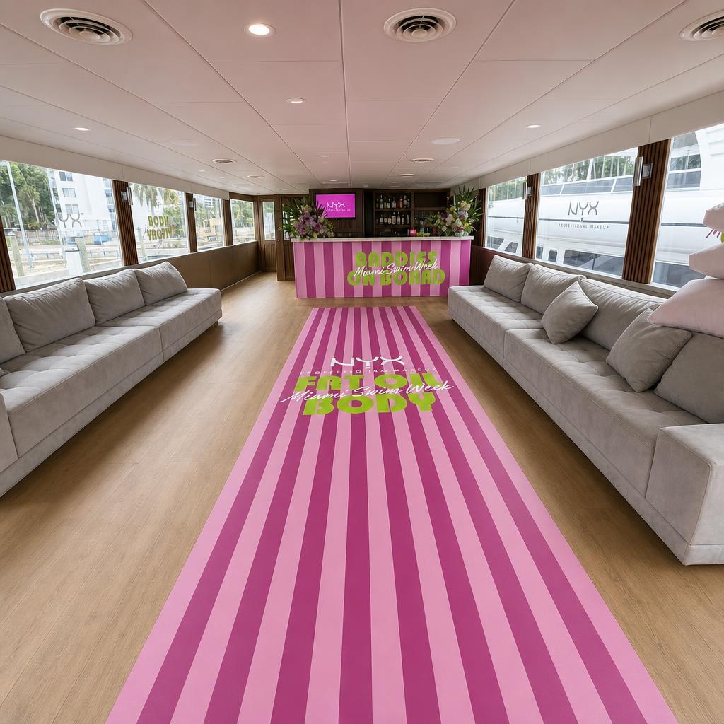 Full-length pink striped NYX Fat Oil Body floor runner down the main cabin of a Miami event yacht